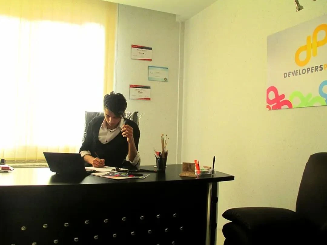 Sajjad at his desk in the Developers Pedia office in 2014, working on a small Samsung netbook.