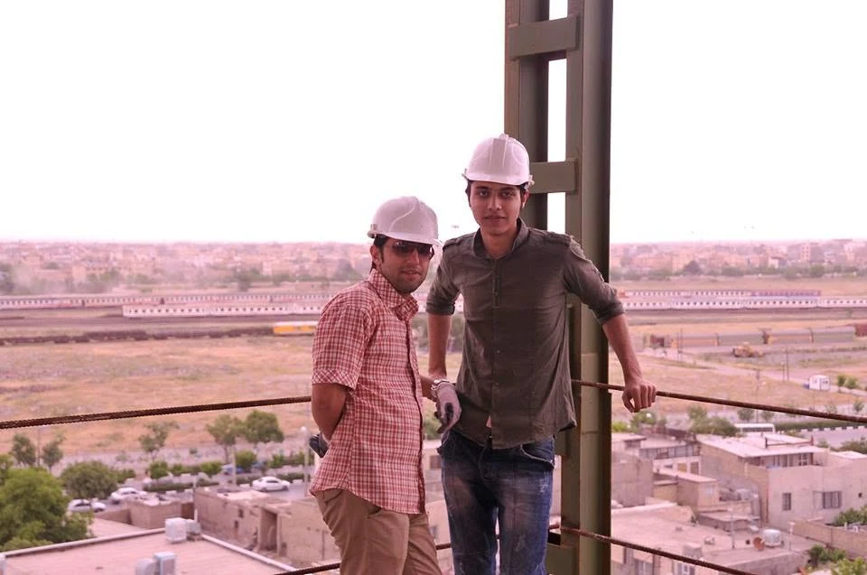 Two colleagues wearing hard hats at the Pardis construction site, from my 2013 archive.